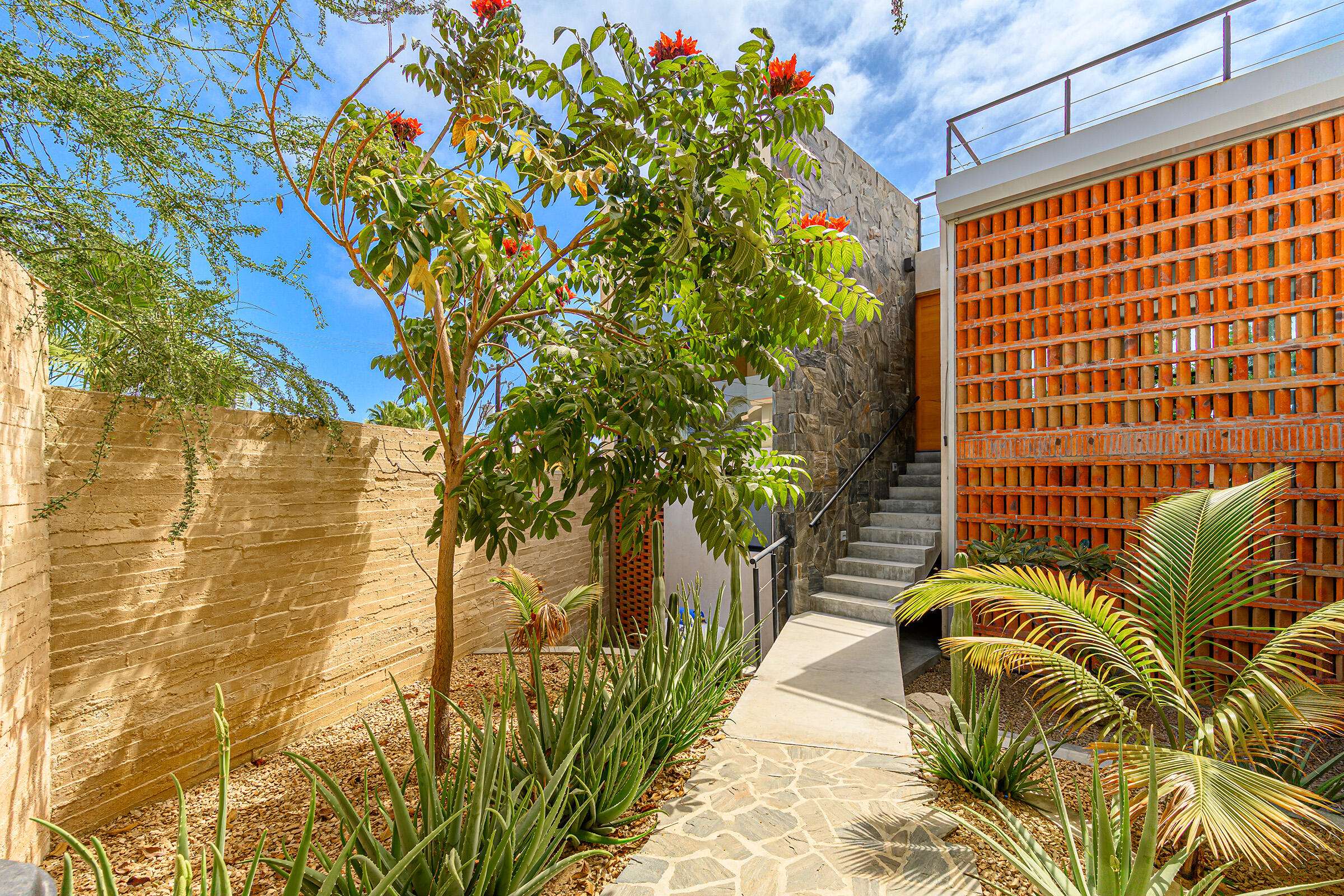 San Jose del Cabo Gringo Hill Tucked into the coveted hillside community of Gringo Hills in Costa Azul, Casa Asha is a contemporary residence by architect Gonzalo Elizarraras. Set on a 519SM lot, the three-bedroom home blends natural Baja materials with modern architecture, open living spaces, and expansive terraces. The upper-level living, dining, and kitchen flow to a generous terrace, while the lower level opens to a lush garden ideal for entertaining under the shade of mature trees. The rooftop offers a versatile space perfect for sunrise yoga, morning coffee, or a barbecue overlooking the Sea of Cortez. A brief 900-meters to the shores of Costa Azul and minutes from San José's historic center, Gringo Hills offers a relaxed lifestyle loved by surfers, artists, and long-time locals. for sale