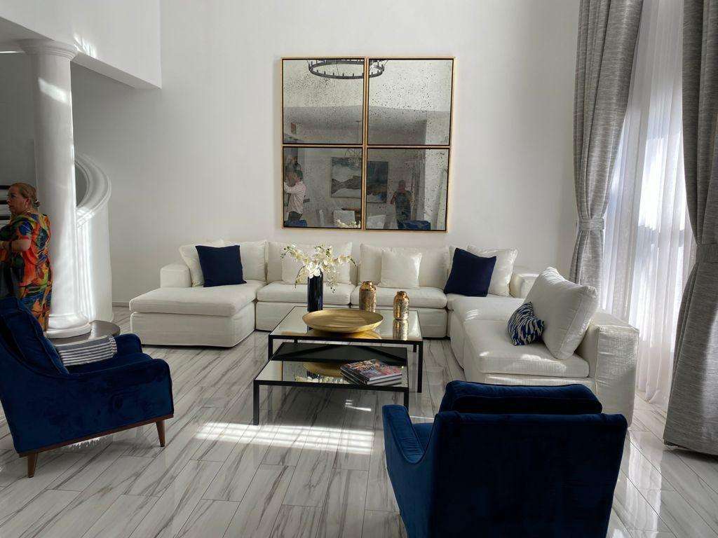 San Jose del Cabo Villas De Oro Phase 1 Villa de Oro fantastic. Number 304 is very unique as it is one of a few town homes (most are upper or lower)that has a massive dramatic two story window that lights up the home. Downstairs has the impressive living and dining room. The kitchen has a new granite counter, a breakfast area and a bar for guests to enjoy the activity in the kitchen. Outside living with a big space to dine and sit around the large stone fireplace. Upstairs there are two bedroom suites, one of which has an outside terrace to enjoy the ocean for sale